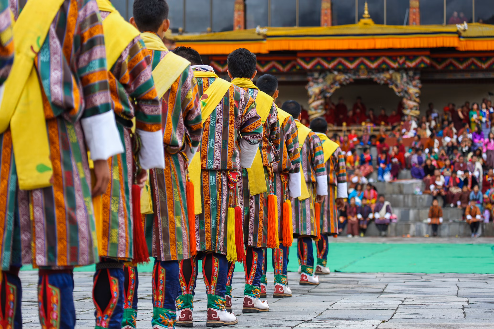 A group of male dancers get ready for a traditional item during Thimphu Tshechu (festival)